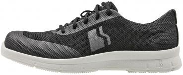 The shoe is sporty and lightweight. It has a black upper with gray accents and laces. The sole is flat and sturdy, ideal for everyday wear or leisure.