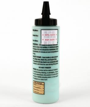 The image shows a bottle with a greenish liquid. It has a black tip and a cap. The bottle has instructions and data printed on it, including storage information.