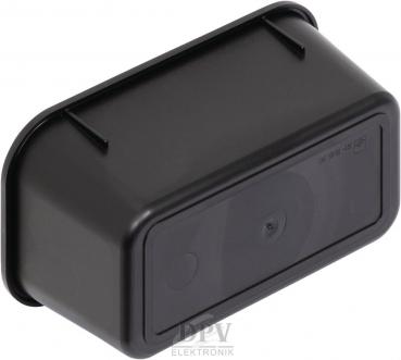 The image displays a black, rectangular object with rounded edges and a smooth surface. On the front, a small, round element is visible. It appears compact and sturdy.