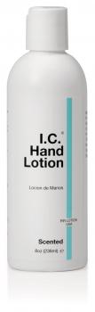 It is a white bottle with a screw cap. On the front it says "I.C. Hand Lotion" in black letters, accompanied by a blue stripe and the note "Scented".