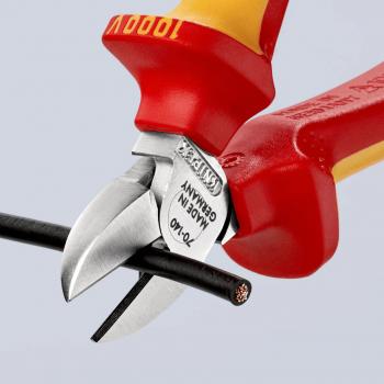 In the picture, there are two wire cutters. The blades are sharp and shiny, while the handles are red and yellow. They are cutting a thin, black wire in the middle.