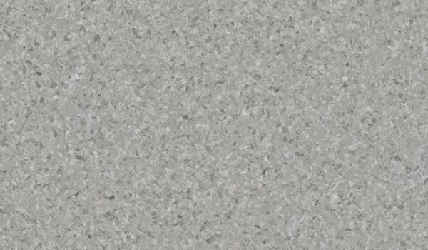 The image displays a uniform, structured surface in various shades of gray. The surface has a fine texture with irregular, small particles that create a lively yet subtle appearance.