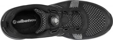 The image shows a black athletic shoe made from breathable material. The lacing is done through a special closure. The lining is also dark, with a white logo.