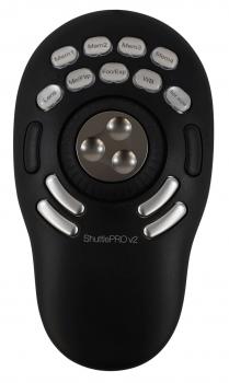 The image displays a black control unit with an oval shape. In the center, there are three buttons arranged in a circle. Above, several labeled buttons are scattered.