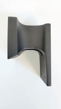 The image shows a black bracket with curved edges. The back is flat and features two holes for mounting. It appears sturdy and has a matte finish.