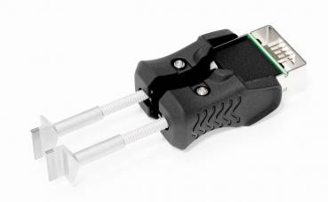 The image shows a black tool with two long, thin metal arms and a connector at one end. It has ergonomic handles and is likely used for inserting or removing electronic components.