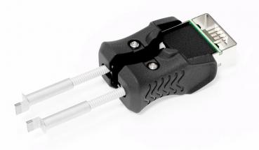 Das Bild zeigt einen Adapter mit zwei silbernen Stiften und einem schwarzen, ergonomisch geformten Griff. Der obere Teil hat einen Anschluss, der an einen USB-Port erinnert.