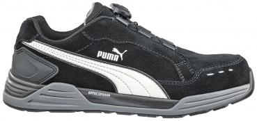 The shoe is black with a white, curved line on the side. It has a sturdy sole and a sporty design, ideal for leisure and activity.