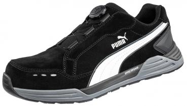 The shoe is a sporty, black suede sneaker with gray and white accents. It features a quick-lacing system with a special closure and a padded sole.
