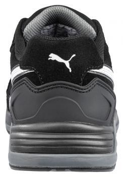 The image displays the rear view of a black shoe. It features a gray sole and a white stripe. A prominent Puma logo is visible. The shoe appears sporty and modern.