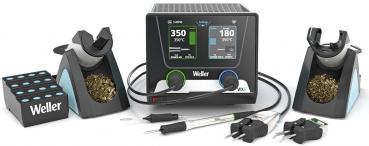 The image shows a soldering station with a digital display in the middle, two soldering tip holders on both sides, a holder for soldering wire, and several cables.
