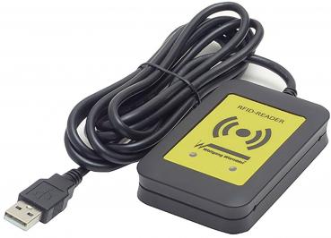 The image shows an RFID reader with a black casing and a yellow marking. A cable with a USB connection leads away from it. The reader is used for wireless data transmission.
