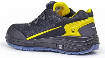 The shoe is black with yellow accents. It has a sporty shape, a thick, textured sole, and a padded insole. The laces are tight and secure.