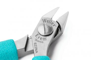 The image shows a precise pair of pliers with narrow, pointed blades. The handle is turquoise, and some markings are engraved on the pliers, including "Weller Erem" and a model number.