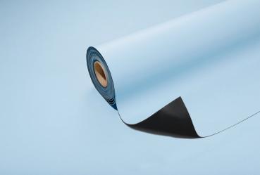 The image shows a roll of blue paper that is partially unrolled. The top side is light blue, the underside is a darker shade. The background is also light blue.
