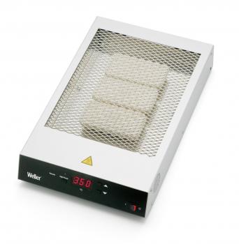 The image displays a square heating device with a metal grid on top and a digital display. It features a triangular warning sign and controls at the bottom.