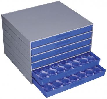 Das Bild zeigt eine flache, graue Schubladenbox mit mehreren Schubladen. Die unterste Schublade ist herausgezogen und enthält 12 runde Vertiefungen. Die Box ist aus Kunststoff, die Schubladen sind blau.