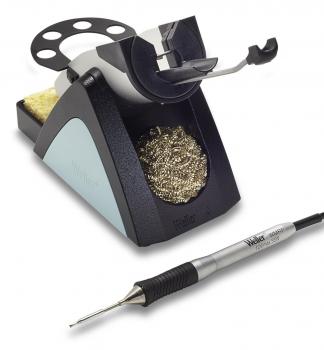 The image shows a soldering station. It consists of a stable base with a holder for a soldering iron, a sponge for cleaning, and a container with solder. A cable connects the iron.