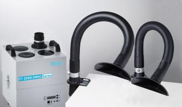 The image shows a smoke extraction device with a rectangular, gray casing and two black, flexible hoses that are bent upwards providing exhaust air.
