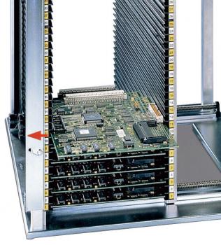The image displays a vertical computer rack with multiple green-painted circuit boards. The boards are stacked in a metal casing, equipped with several connectors and slots.