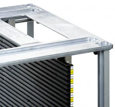 The image displays a metal frame with a flat surface and a vertical arrangement of black, ridged plates. Numbered markings are visible on the left side.