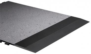 The image displays a rectangular floor panel in shades of gray. The surface is slightly textured and contains small, light inclusions. Along one edge, there is a black transition.