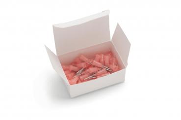 Eine offene, weiße Schachtel enthält mehrere kleine, pinkfarbene Teile mit metallischen Spitzen. Die Teile scheinen Zubehör oder Halterungen zu sein, die in der Schachtel chaotisch angeordnet sind.