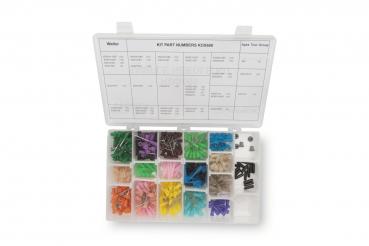 The image shows an open, transparent plastic box with various compartments. Each compartment contains small parts of different colors and shapes, likely for crafts or model building.