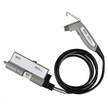 The image shows a device with a gray casing and a black application. It has a hose leading to a handle that has a small opening.