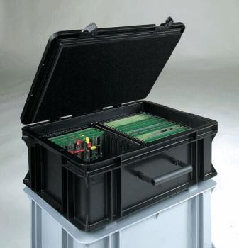 The image shows a dark, square plastic container. On the top, there is a clip closure that secures the lid. The bottom has some structural lines and indentations.