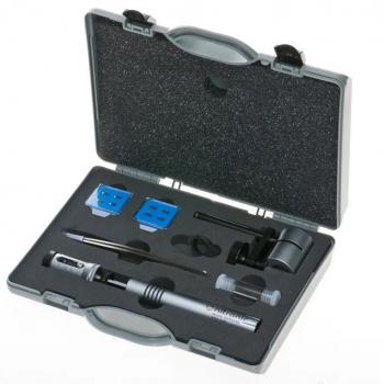 The image displays a toolbox with various instruments. The box is gray and features a foam insert. Included are a screwdriver, two blue parts, and additional small tools.