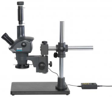 The image shows a microscope with a stable, black base. It has a telescope-like lens, a lateral eyepiece, and a vertical mount that supports the work area. A cable terminates in a control unit.