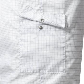 The image displays a section of a shirt made from light fabric featuring a checkered pattern. It includes a chest pocket that is secured with a flap and two snap buttons.