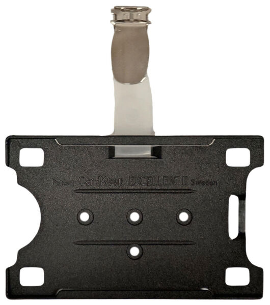 The image shows a black bracket with a metallic connection at the top. The bracket has four holes and a central slot-groove design. It appears sturdy and functional.