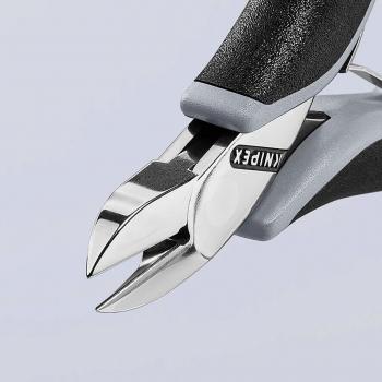 The image shows a high-quality nail scissors with shiny, sharp blades and ergonomic, gray rubber handles. It is designed for precise cutting.