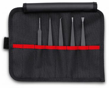The image shows a black tool bag that is unfolded. Inside there are five black tools of various shapes and lengths, neatly arranged within a red seam.