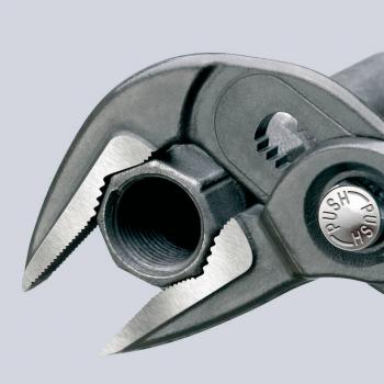 The image shows a pair of pliers with two movable jaws and a round opening. The pliers have a gray handle and a silver, round button labeled "PUSH".