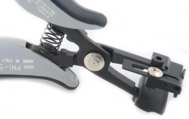 The image shows a gray pliers with a spring-loaded opening and a sturdy holder, used for precise work. One part is adjustable and includes screw locks.