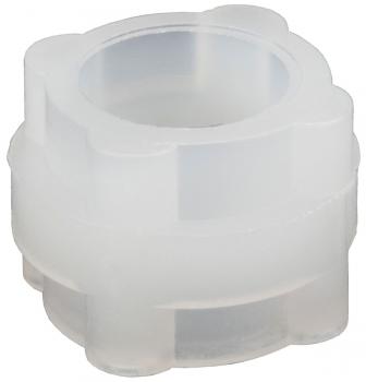 The image shows a transparent, sculptural object with a round opening in the middle. It has a flower-like shape and is slightly wavy at the edges. The surface feels smooth.