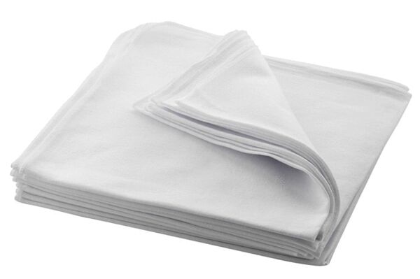 The image displays multiple overlapping, folded white towels. The towels feature a soft, smooth texture and are neatly stacked. One towel is slightly unfolded.