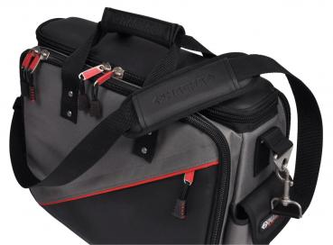 The image shows a gray bag with red accents. It has two handles, a detachable shoulder strap, and several pockets with zippers. The surface is durable.