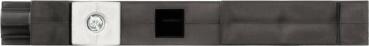 The image shows an elongated, rectangular object in dark colors, which has a white field with a symbol or logo on one side. On the opposite side, there is a small black area visible.