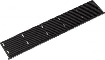 The image shows a long, flat piece in black with many parallel grooves. It has a straight shape and is possibly a component for a technical device or a machine.