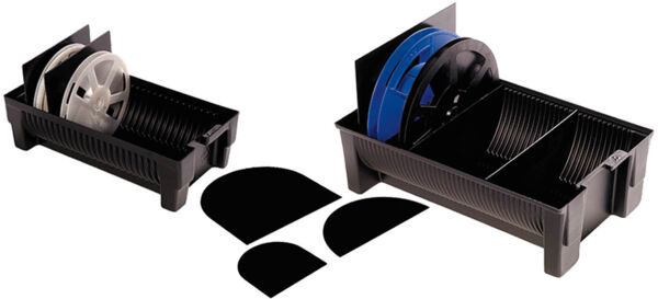 The image shows a black container with four round, white plates. One of the plates is tilted and two black dividers stand in the box. The structure is functional and simple.