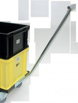 The image shows a cart with two storage boxes. On top is a black box, and below it a yellow one. The cart has an elongated handle for pushing and moves on rollers.