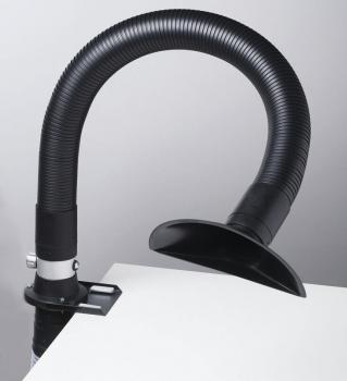 The image shows a flexible, black hose attached to a table. At the end of the hose, there is a round, open shaft. The hose is likely used for extracting fumes or dust.