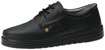 The shoe is black, made of textured leather with a sporty silhouette. It has a flat sole, lacing, and a yellow side marking.