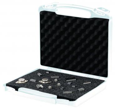 The image shows an open white box with black foam. Inside, various electronic components such as chips and other small metal parts are organized and visible.