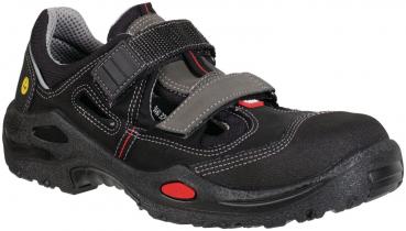 The shoe is black with gray and red accents. It has two adjustable Velcro straps and a sturdy, non-slip sole. Ideal for sports activities or work.