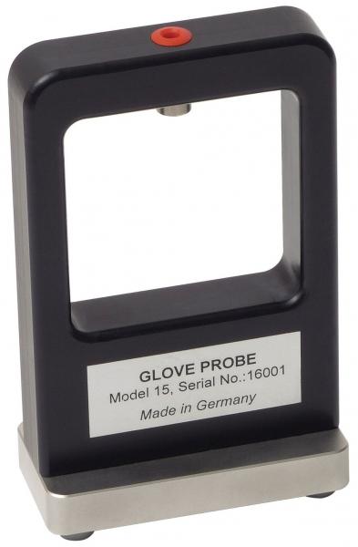 The image shows a rectangular device with an open frame, topped with a red button. It stands on a wide, stable base. A labeled metal plate is attached to the front.